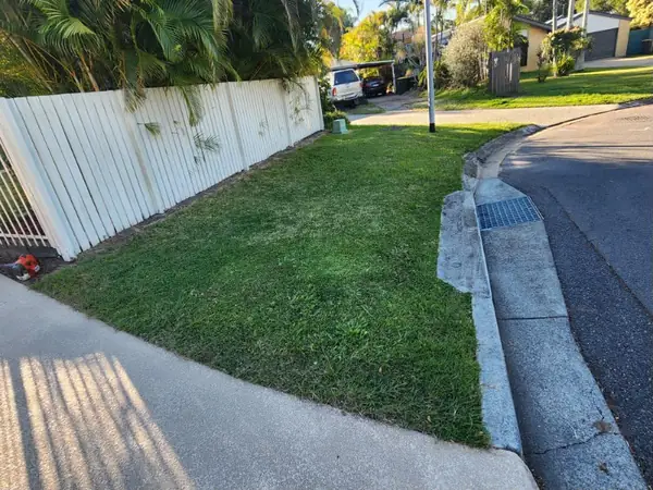 Footpath and kerb strip mown and edged along a residential street