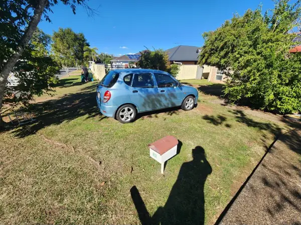 Front yard mown around a letterbox on a wide residential block