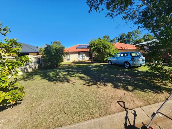 Open front yard mown evenly across a wide residential block